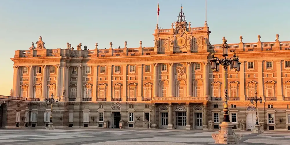 Palace façade and street lamps in warm light