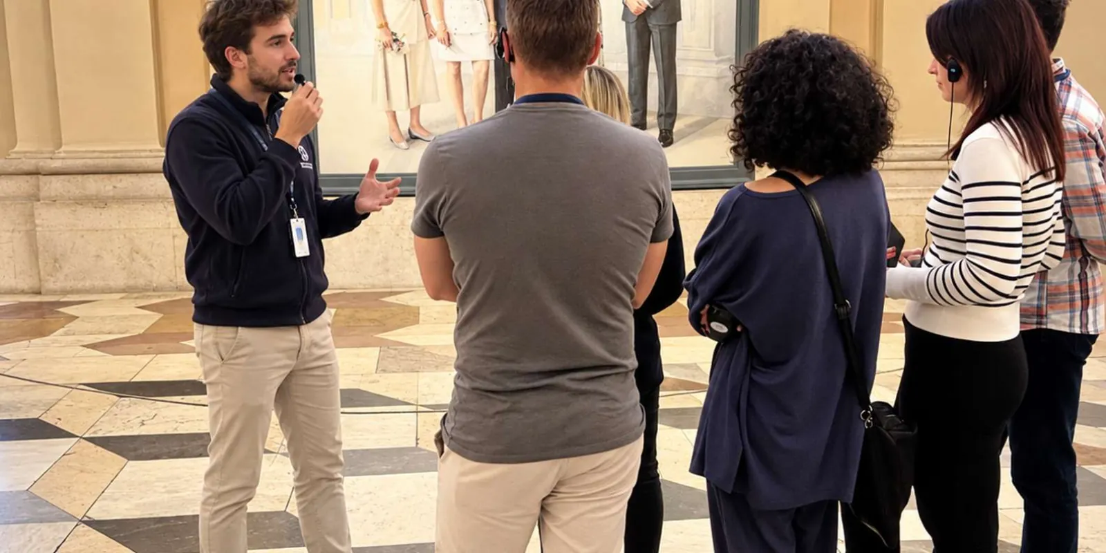 A guide speaking with two visitors