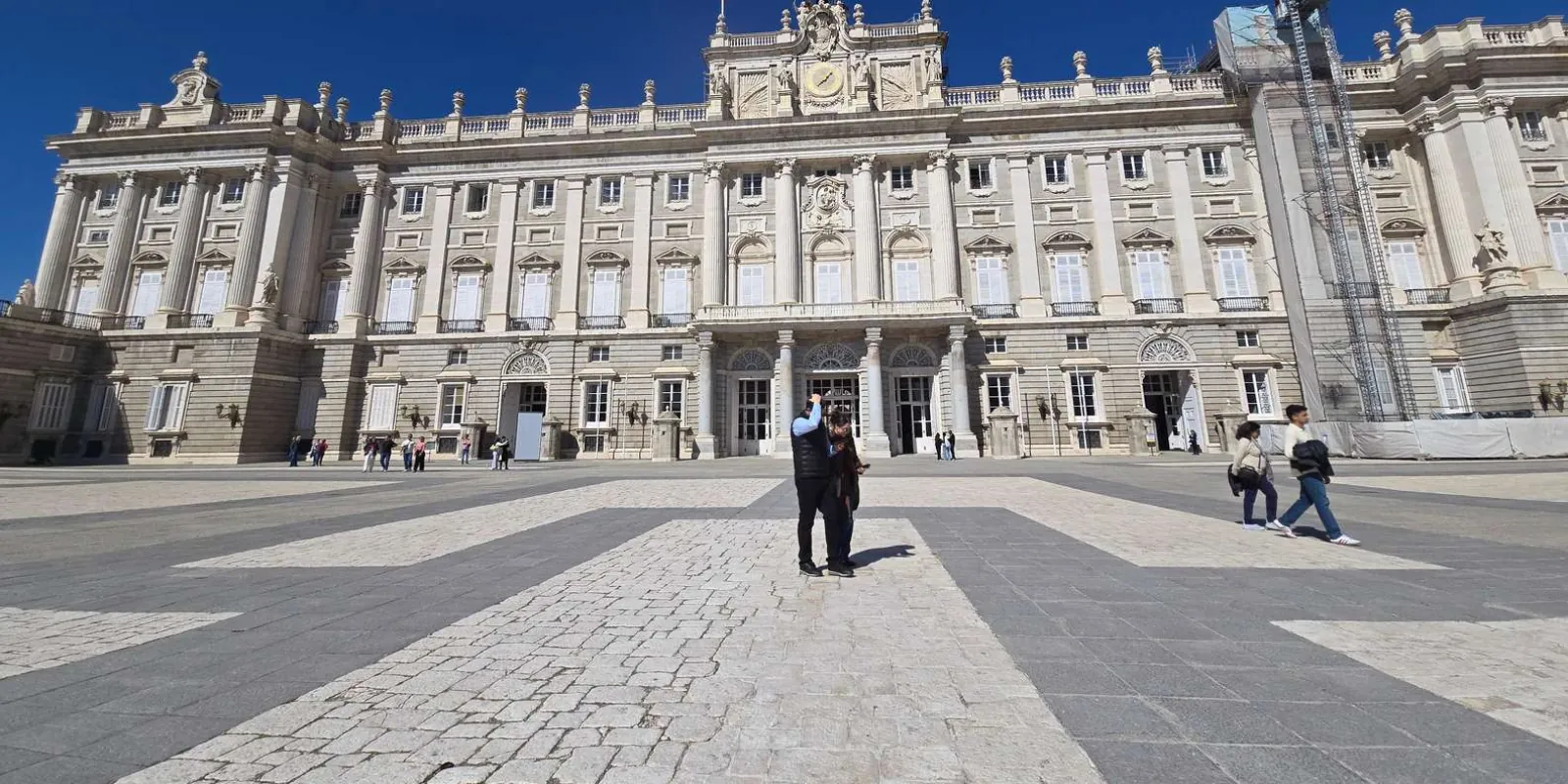 Visitors crossing the palace forecourt