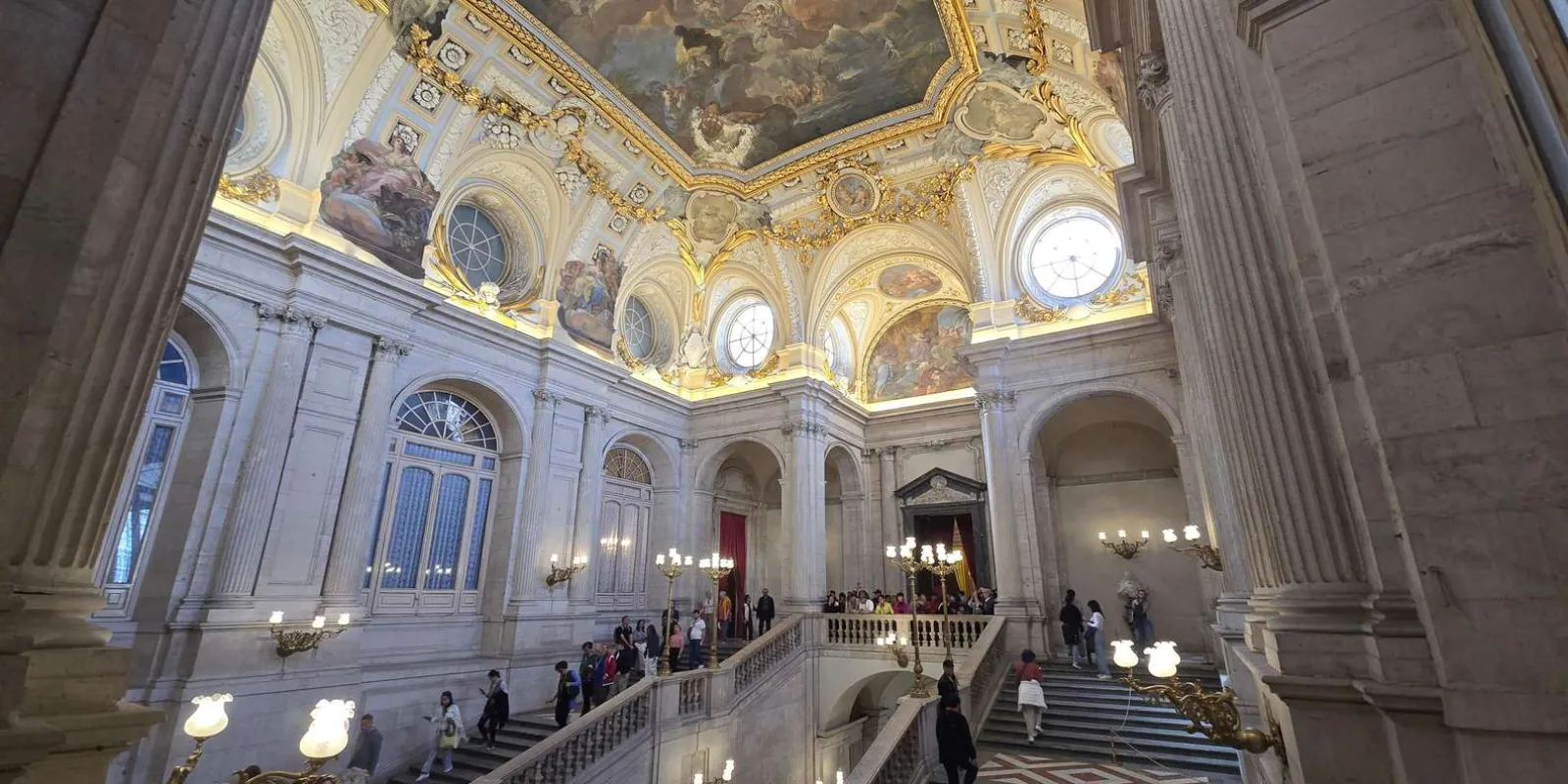 Grand staircase beneath a painted ceiling