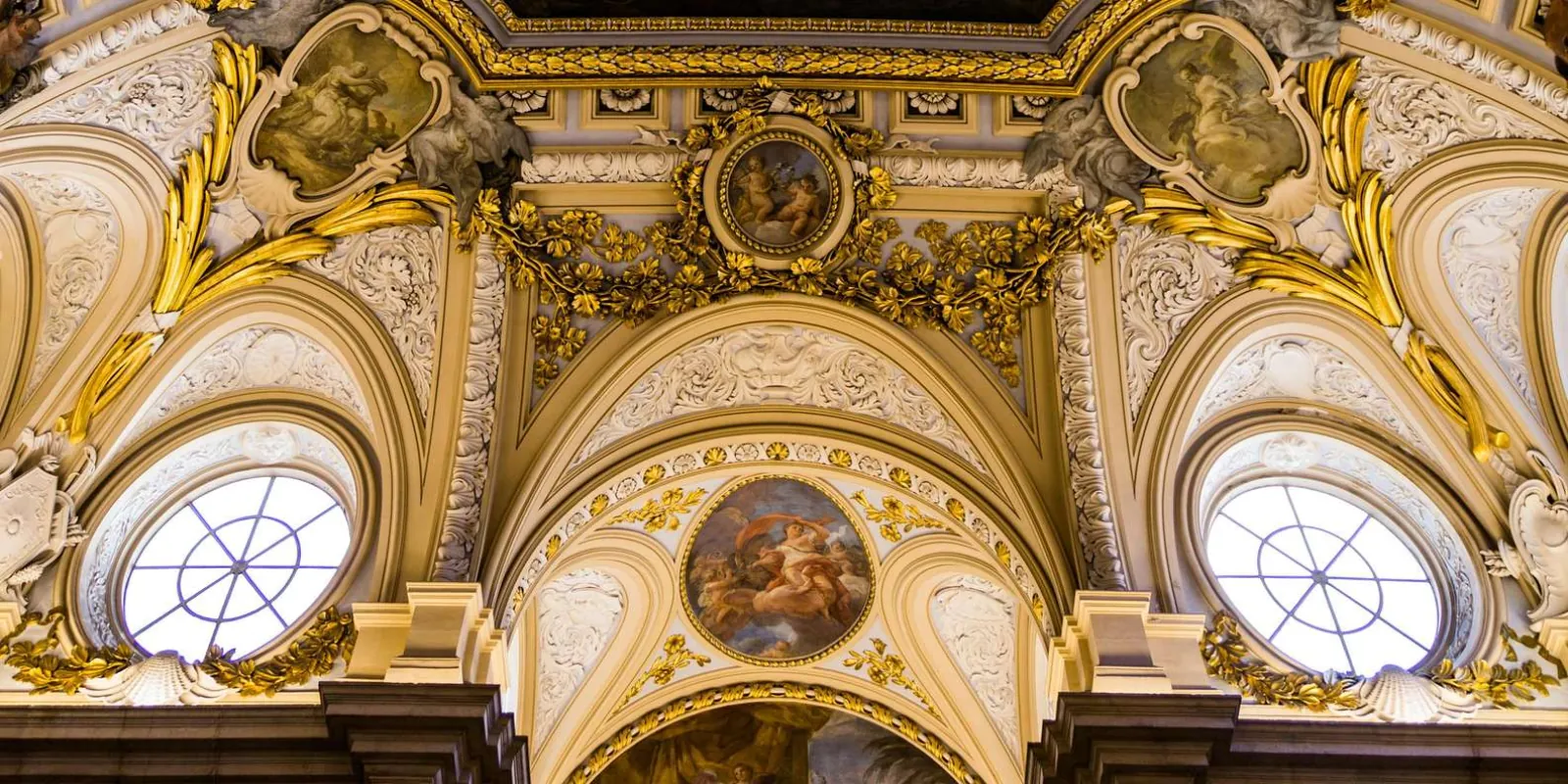 Gilded architectural decoration and round windows