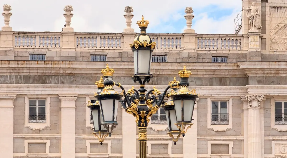 Ornate street lamp in front of the palace façade